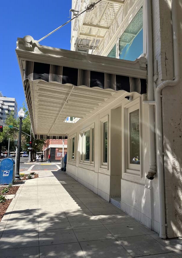 Restored metal awning, new downspout, added curbside landscaping
